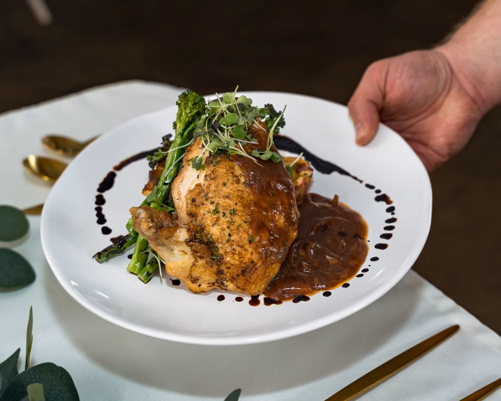 Plated chicken with demi-glace and asparagus