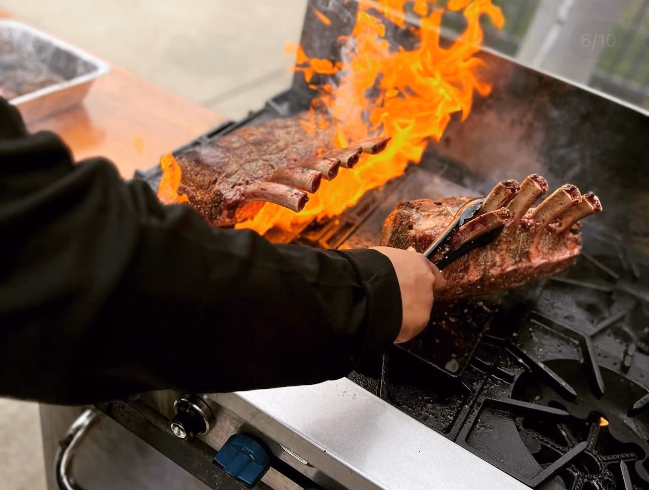 Chef flambéing steak at a live station