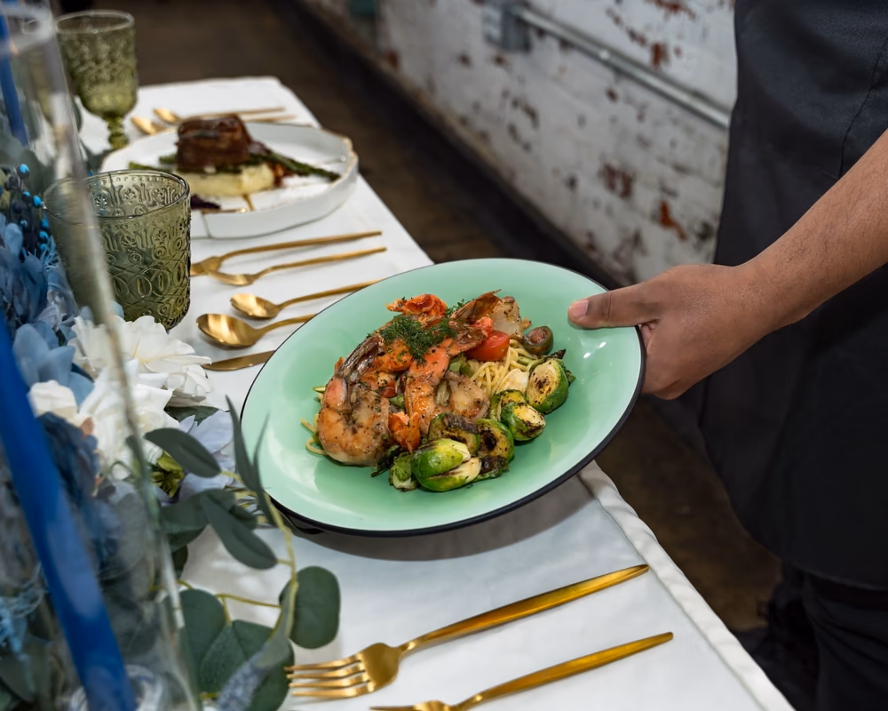 Plated entrée with greens served at the table